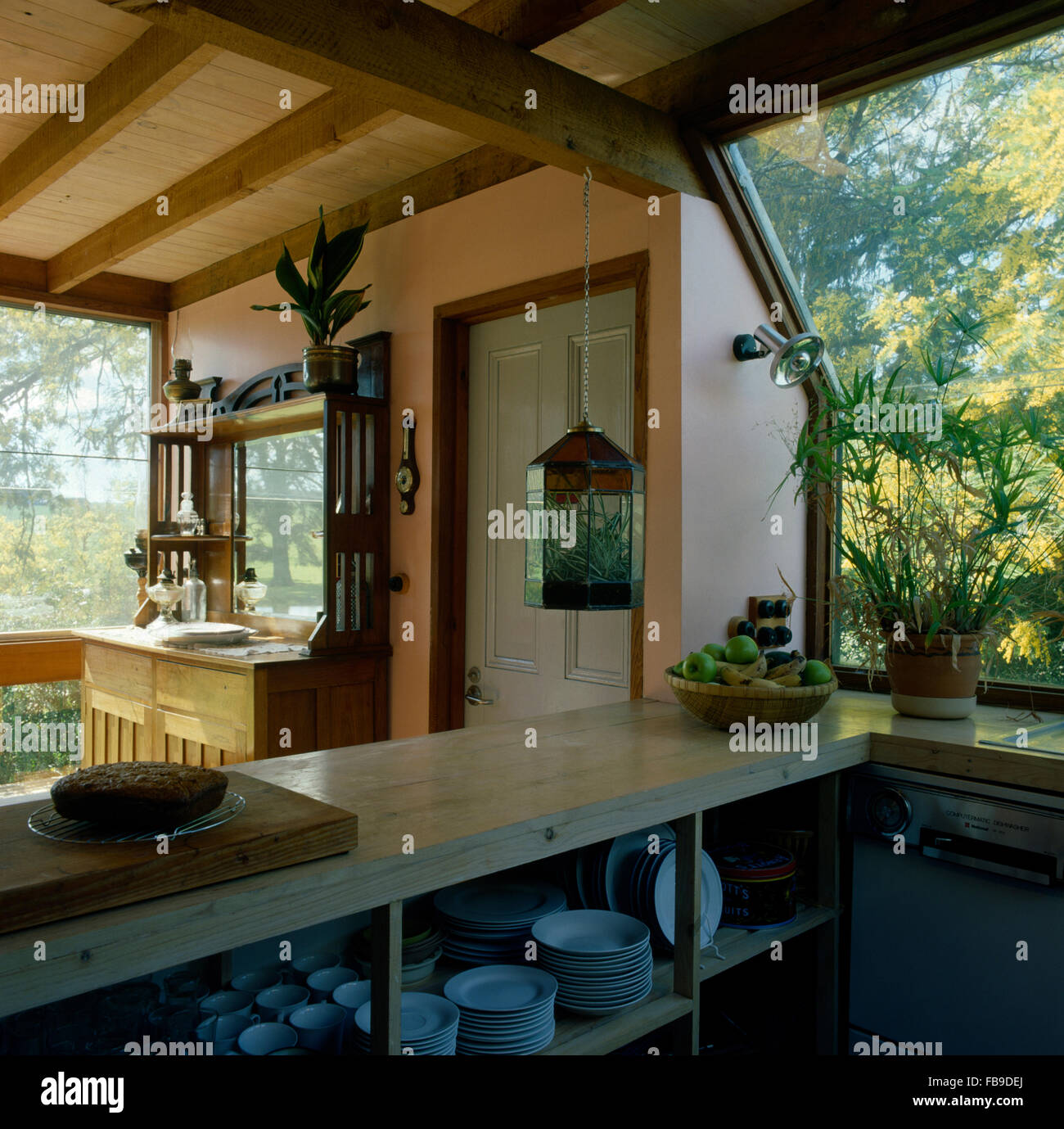 Crockery On Open Shelves In A Nineties Country Kitchen With A