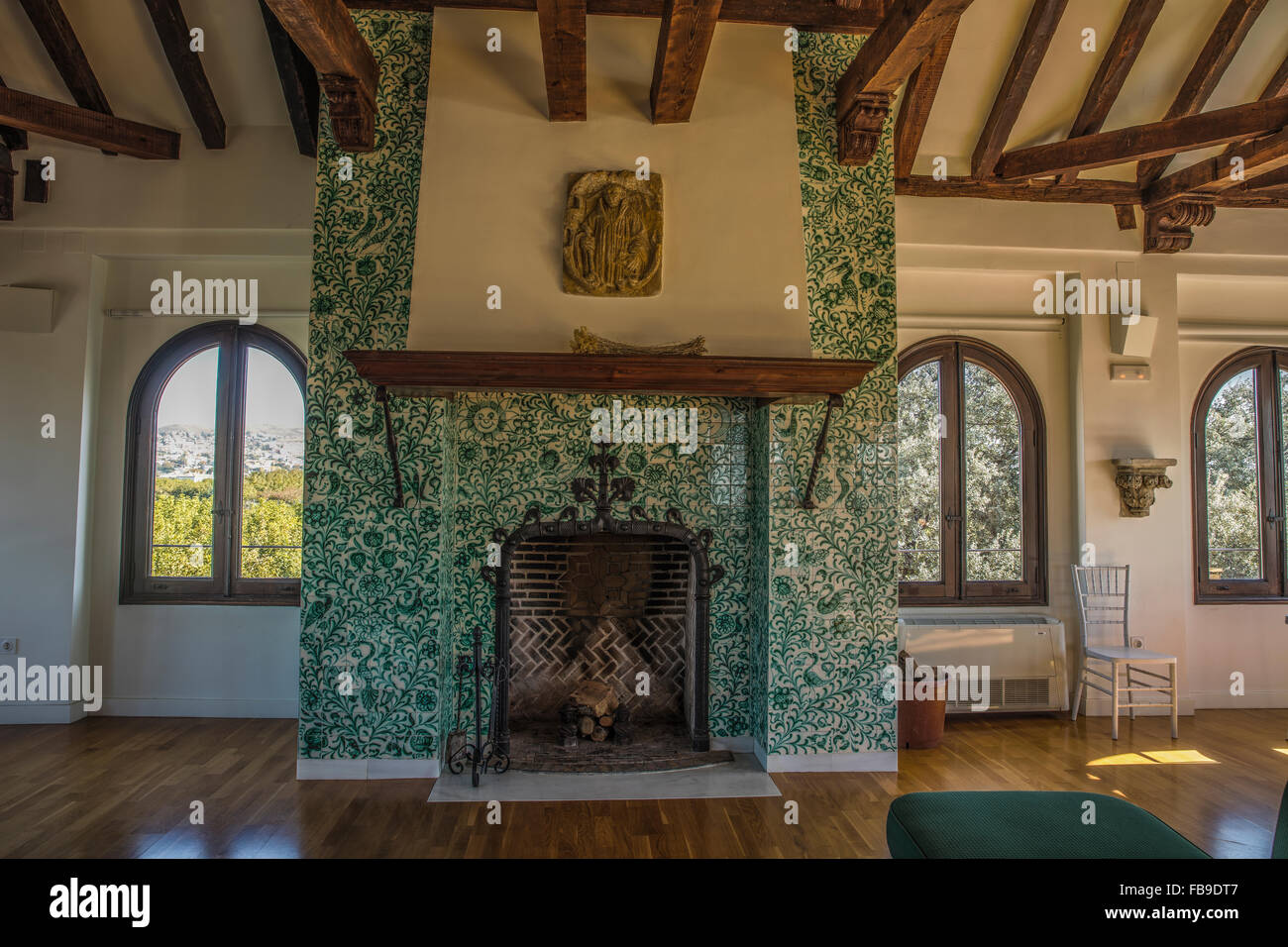 Fireplace In A Lounge With Ceramic Tile Surround And Wooden Beam