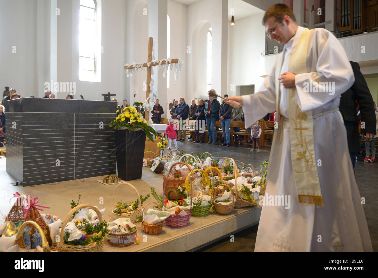 Polish Catholic Priest Blessing easter breakfast food in Polish church in Germany Stock Photo