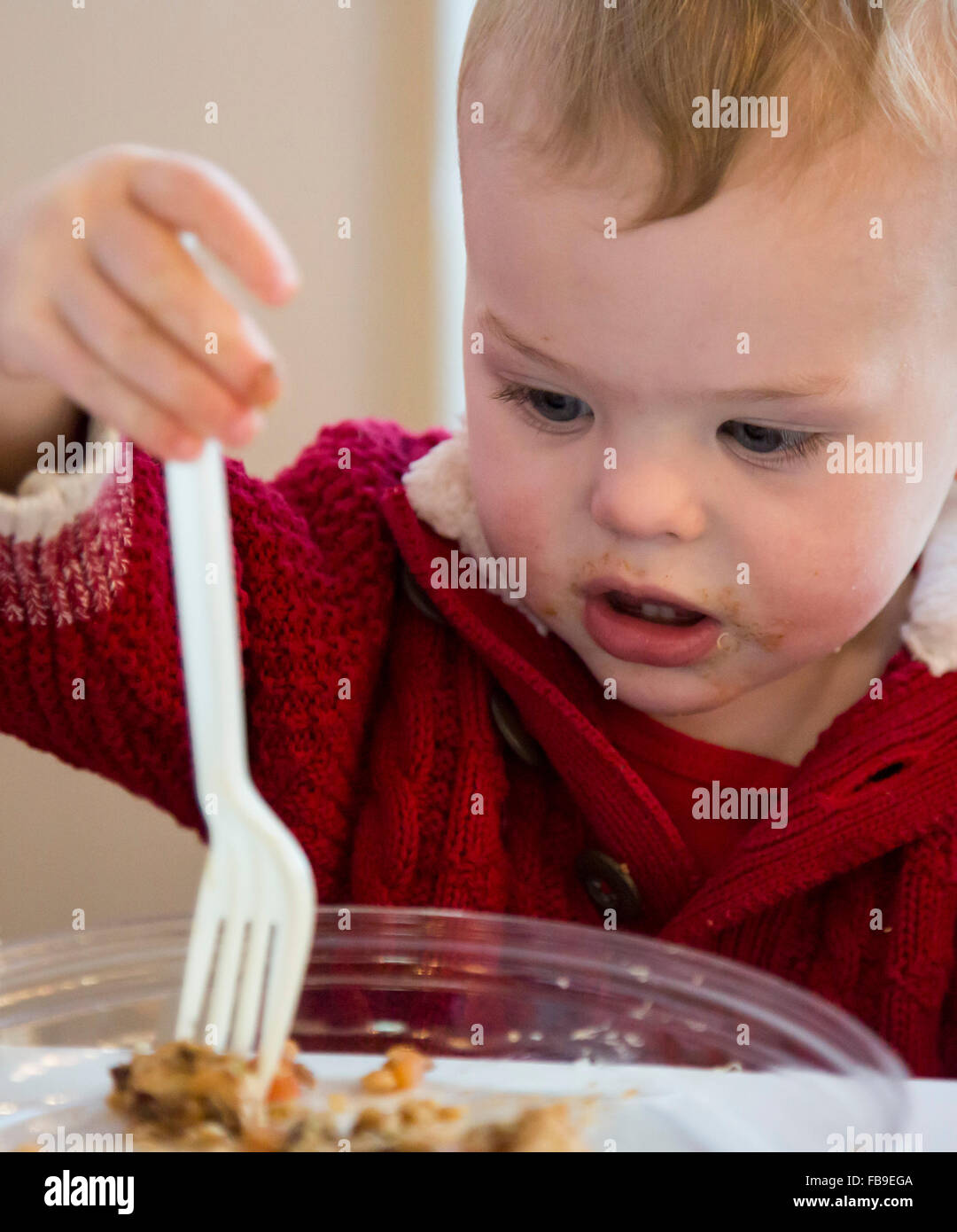 Denver, Colorado - Adam Hjermstad Jr., 17 months old, learns to eat with a fork. Stock Photo