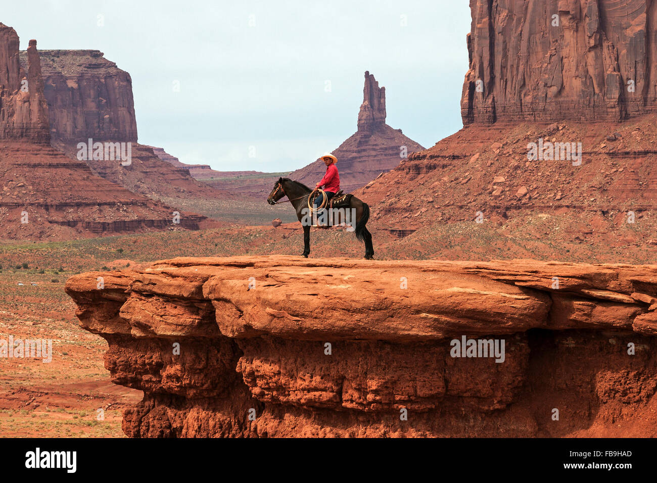 Rock formations, Indian on horse at John Wayne Point, Monument Valley Navajo Tribal Park, Arizona, USA Stock Photo