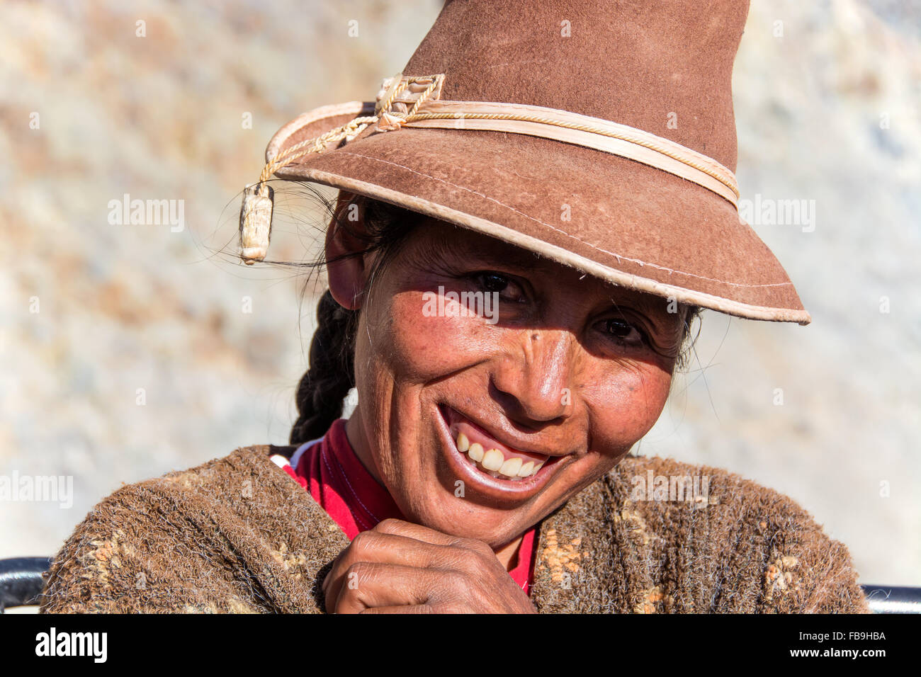 Indigenous woman with hat, laughing, Cusco, Peru Stock Photo