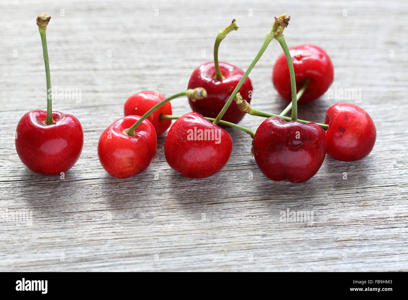 Close up of Prunus avium cherries or known as Lapin cherries on wooden board Stock Photo