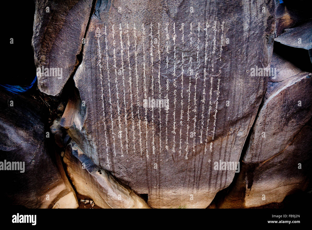 Centuries old Buddhist petroglyphs carved in Mongol script (Hudum Mongol bichig) in a remote part of the Gobi Desert, Mongolia. Stock Photo