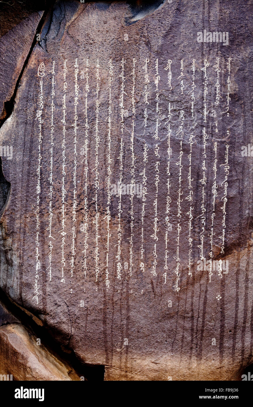 Centuries old Buddhist petroglyphs carved in Mongol script (Hudum Mongol bichig) in a remote part of the Gobi Desert, Mongolia. Stock Photo