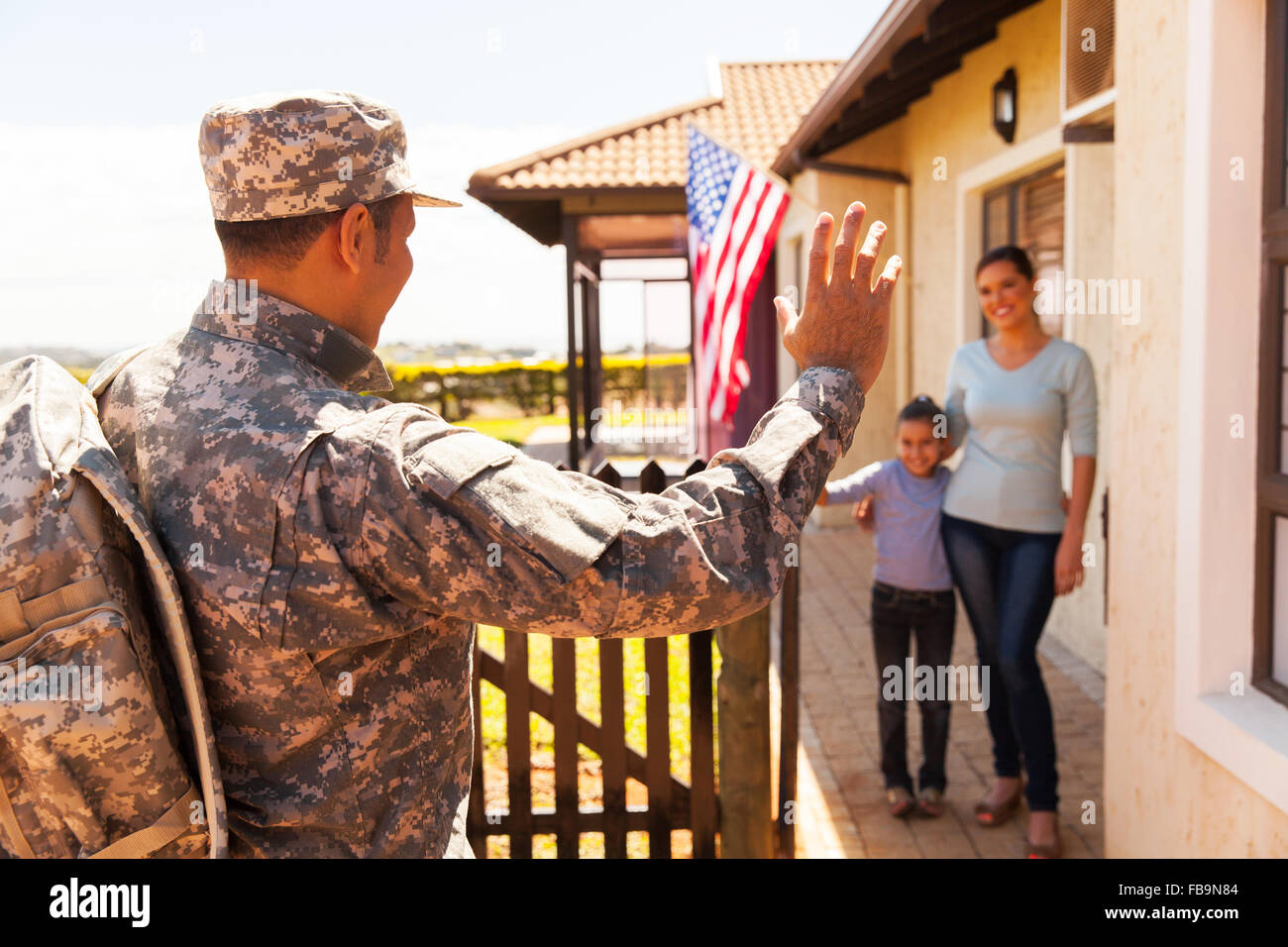 military soldier arriving home with family welcoming him Stock Photo