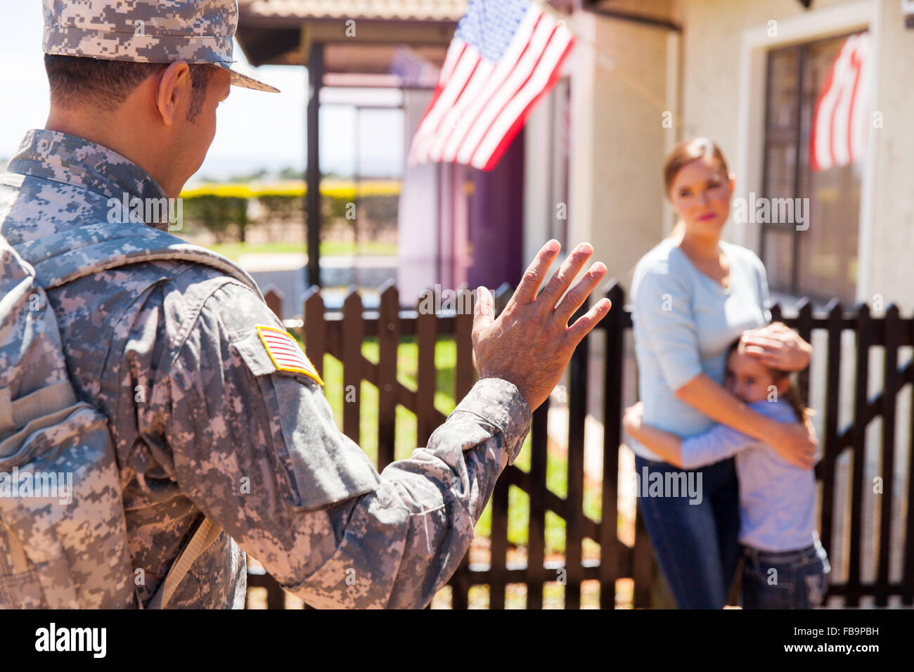 military father waving goodbye to his sad family Stock Photo
