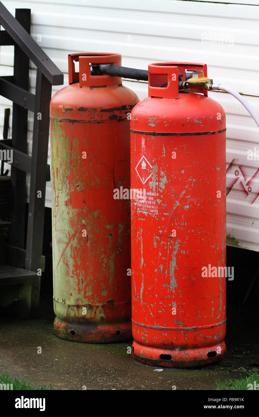 Propane gas bottles in dirty condition at static caravan. Stock Photo