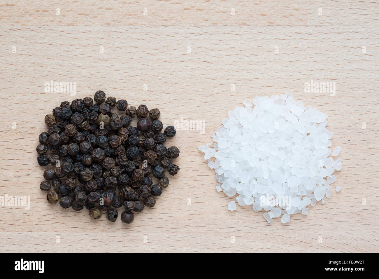Heaps of rock salt and black pepper corns Stock Photo Alamy