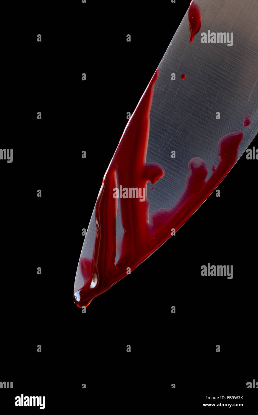 Kitchen knife dripping blood on black Stock Photo