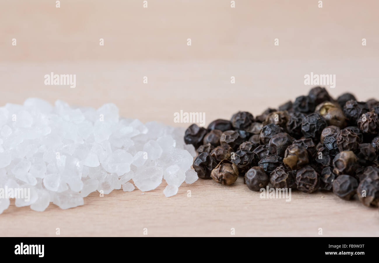 Heaps of rock salt and black pepper corns Stock Photo Alamy