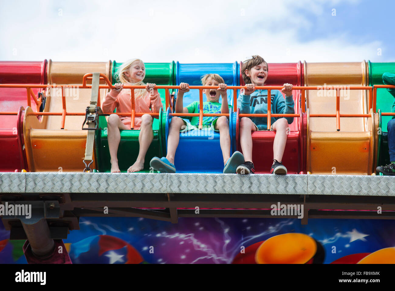 Sweden, Skane, Simrishamn, Excited children (10-11, 12-13) in amusement park Stock Photo