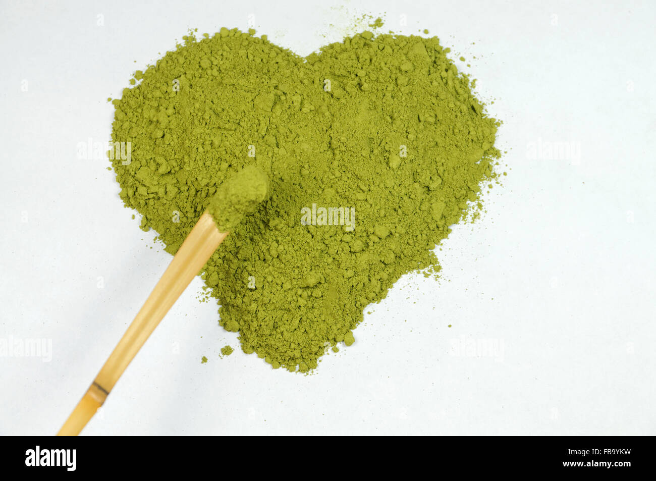 Matcha tea in the shape of a heart and Chashaku Tea Scoop. Stock Photo