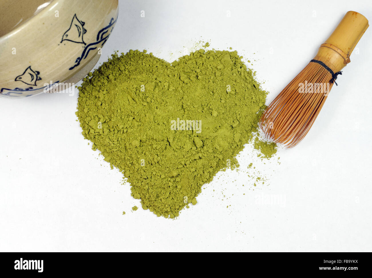 Matcha tea in the shape of a heart, with Chawan tea bowl and Chasen Whisk. Stock Photo
