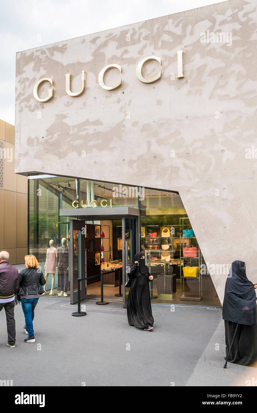 somewhat older woman wearing a burqa and holding a walking cane in front of  the gucci-store, outlet city, metzingen Stock Photo - Alamy