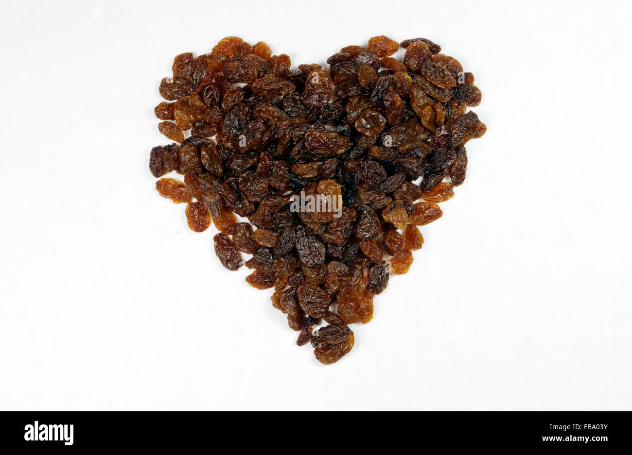 Sultanas in the shape of a heart. Stock Photo