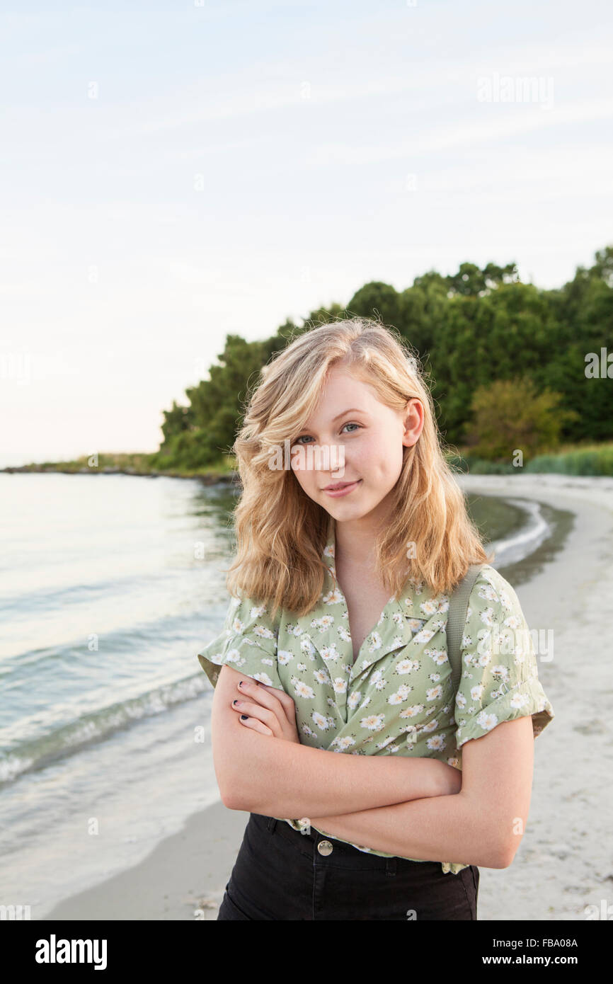 Sweden, Blekinge, Hallevik, Portrait of teenage girl (16-17) standing on beach Stock Photo