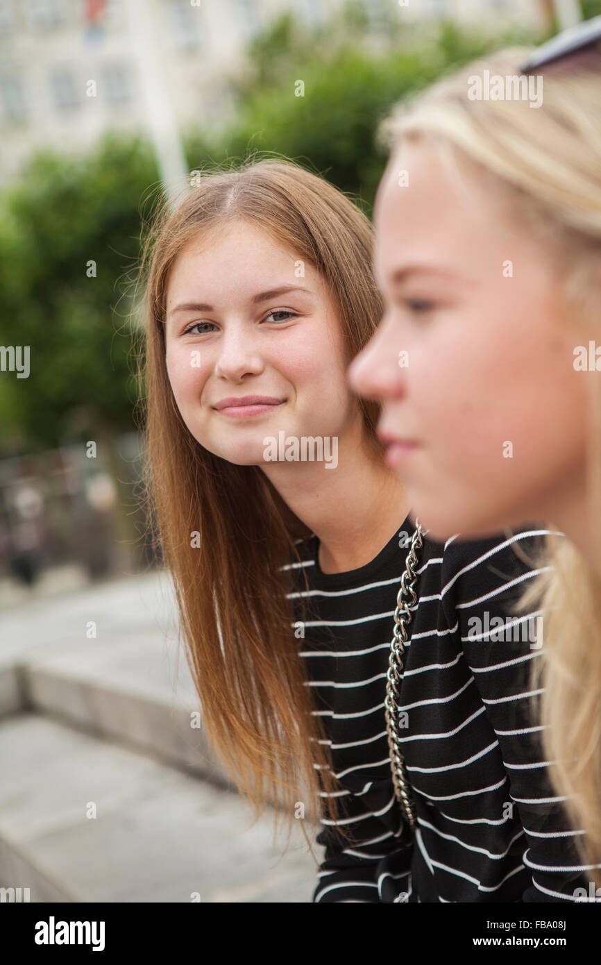 Sweden, Skane, Malmo, Two teenage girls (14-15, 16-17) on street Stock Photo