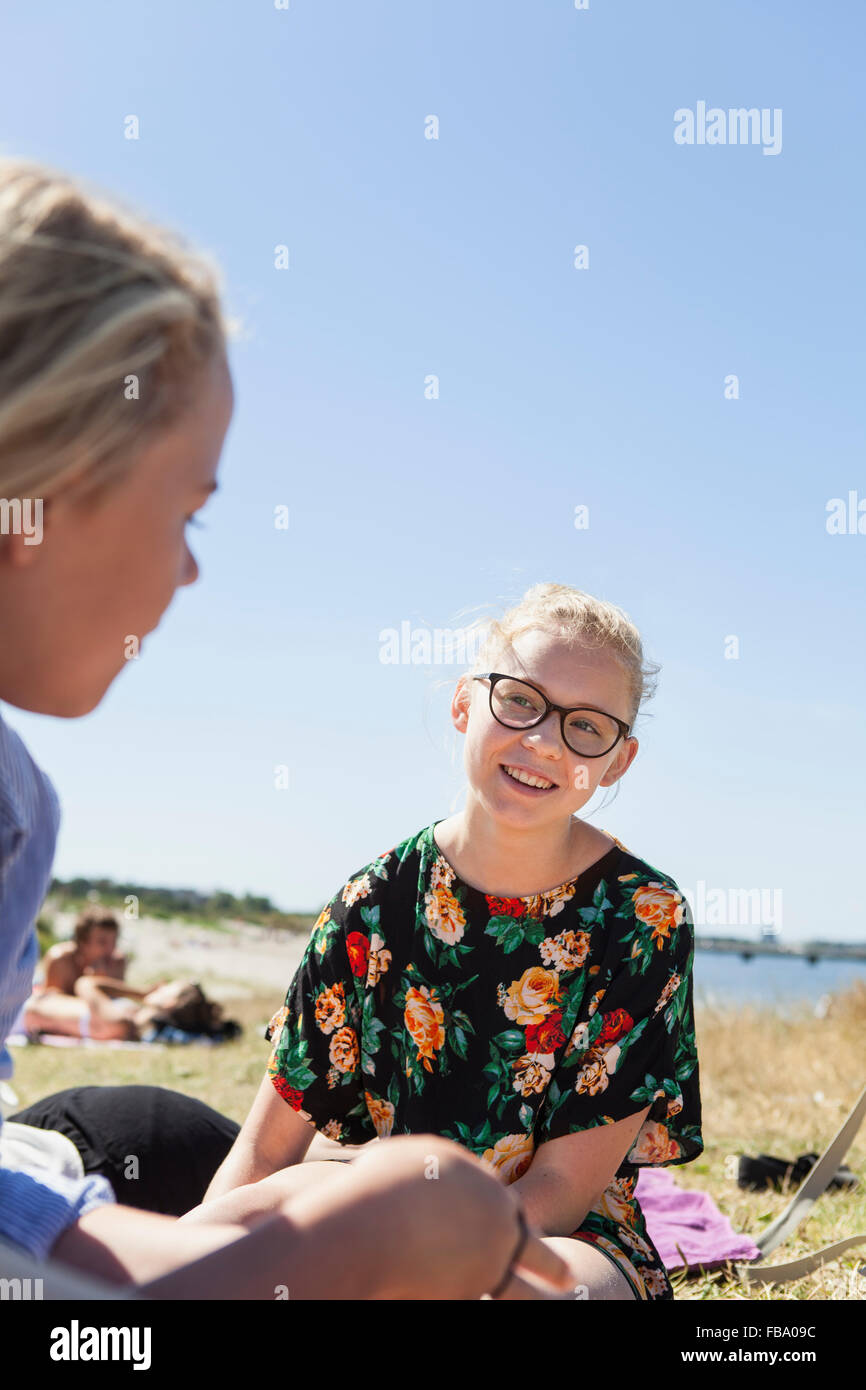 Sweden, Skane, Malmo, Two teenage girls (14-15, 16-17) relaxing at riverbank in Ribersborgs stranden Stock Photo