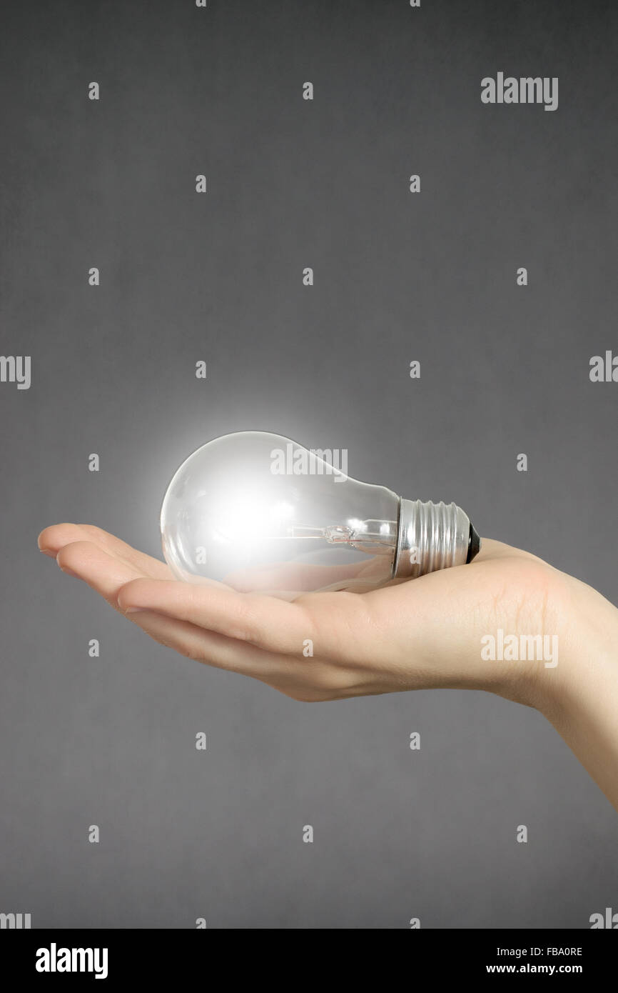 Idea concept. Hand holding a glowing light bulb Stock Photo - Alamy