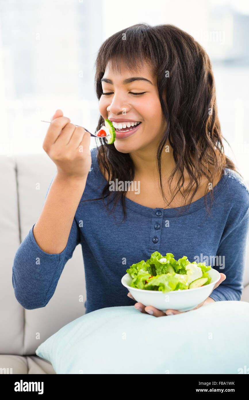 Casual smiling woman eating salad Stock Photo Alamy