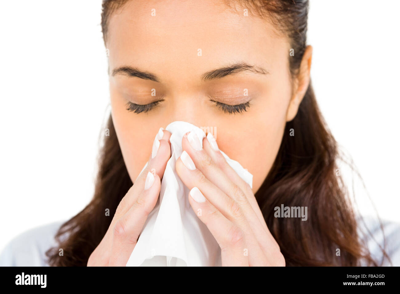 Woman blowing nose with tissue paper Stock Photo