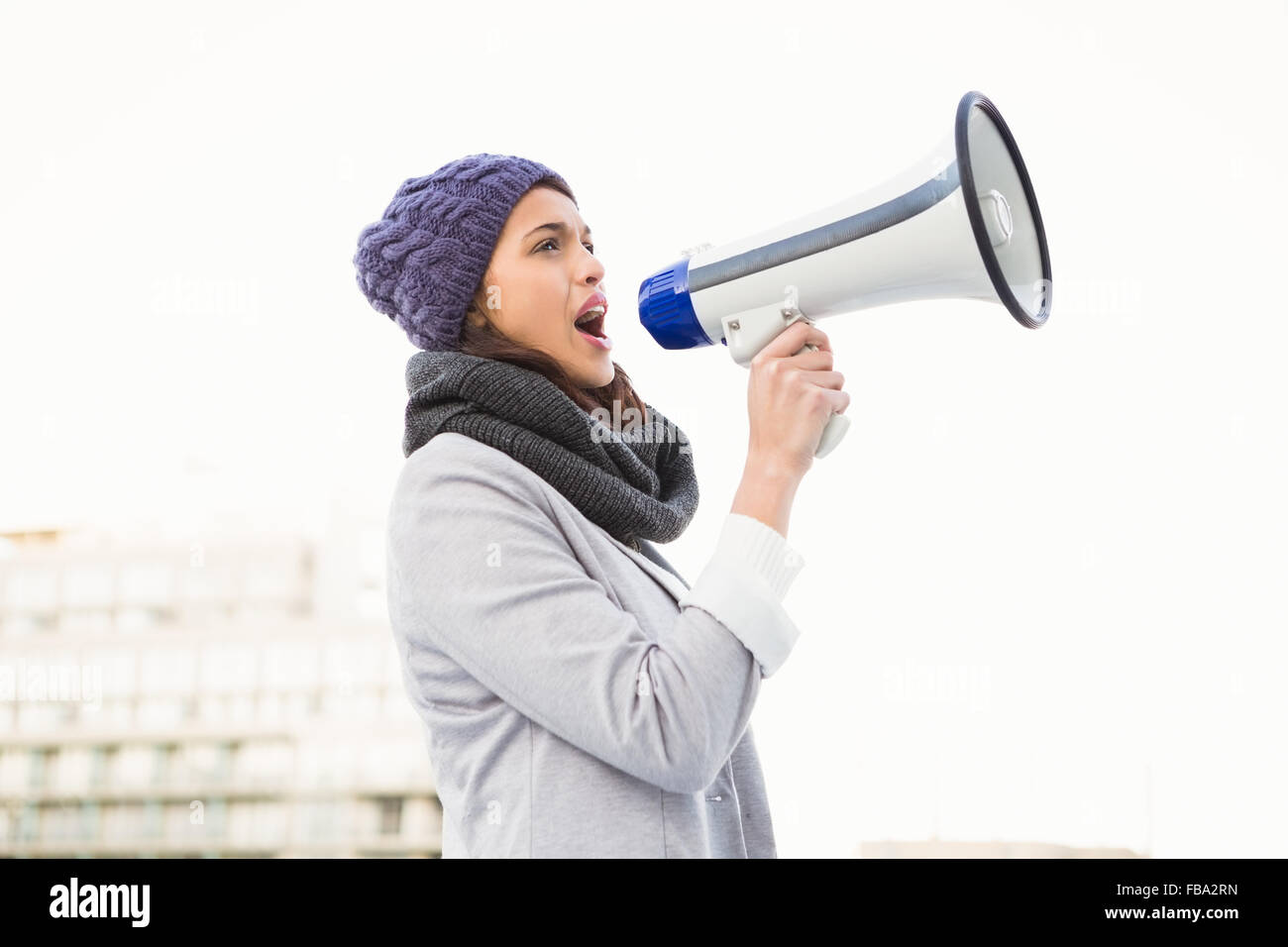 Serious woman shouting with megaphone Stock Photo