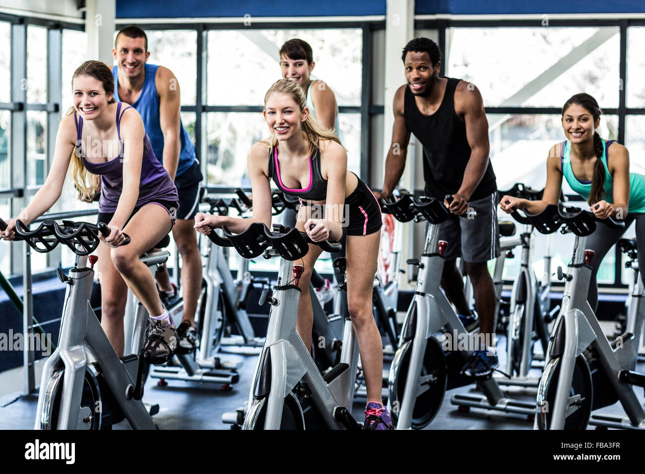 Fit people working out at spinning class Stock Photo