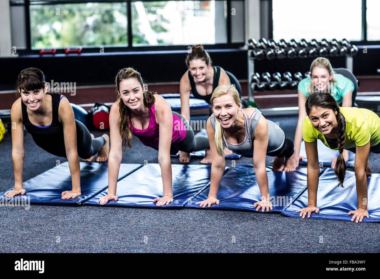 Fit smiling group doing stretching Stock Photo - Alamy