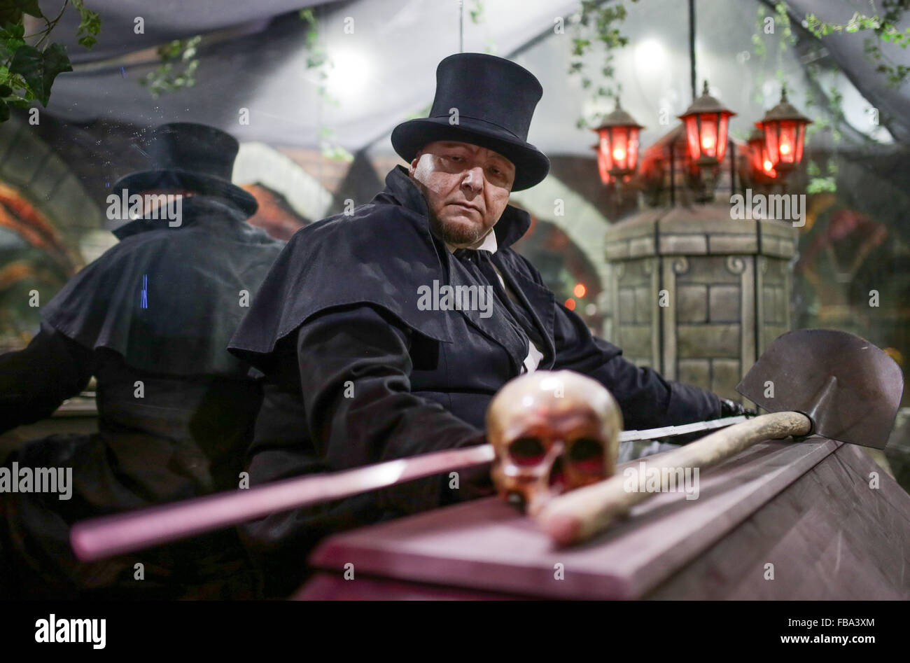 Actor Helmut measures a coffin with a measuring stick in the 'Hamburg Dungeon' in Hamburg, Germany, 13 January 2016. In the 'Dungeon,' a combination of show, chamber of horrors, and fun ride, the entire operation will be reviewed during an annual inventory. Photo: AXEL HEIMKEN/dpa Stock Photo