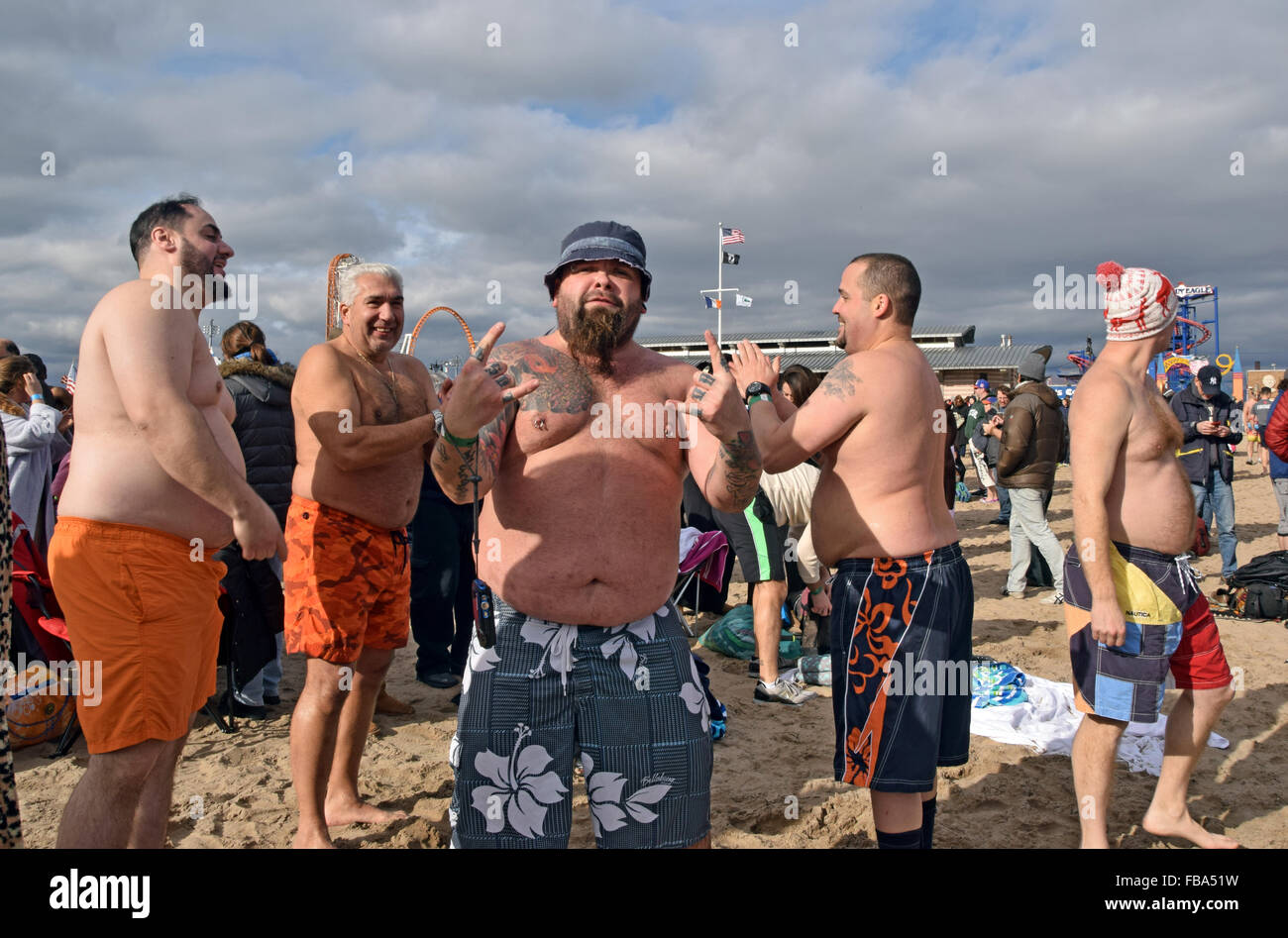 A group of men posing on the beach in Coney Island, Brooklyn on New Years day after their swim with the Polar Bear Club. Stock Photo