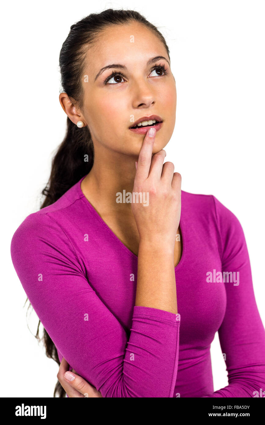 Thoughtful woman with finger on mouth Stock Photo
