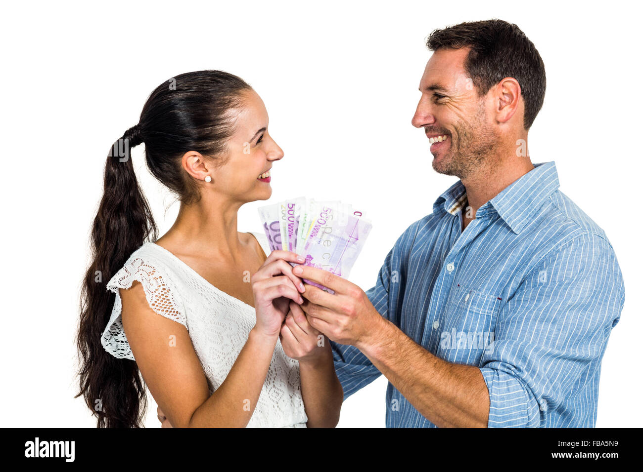 Smiling couple holding money Stock Photo - Alamy