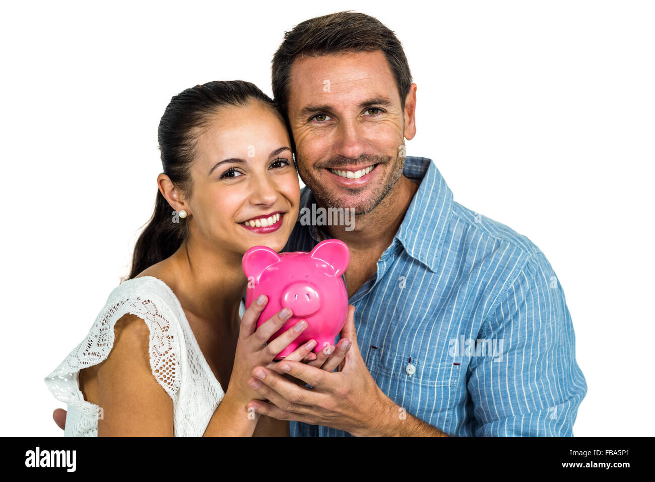 Smiling couple holding pink piggybank Stock Photo - Alamy