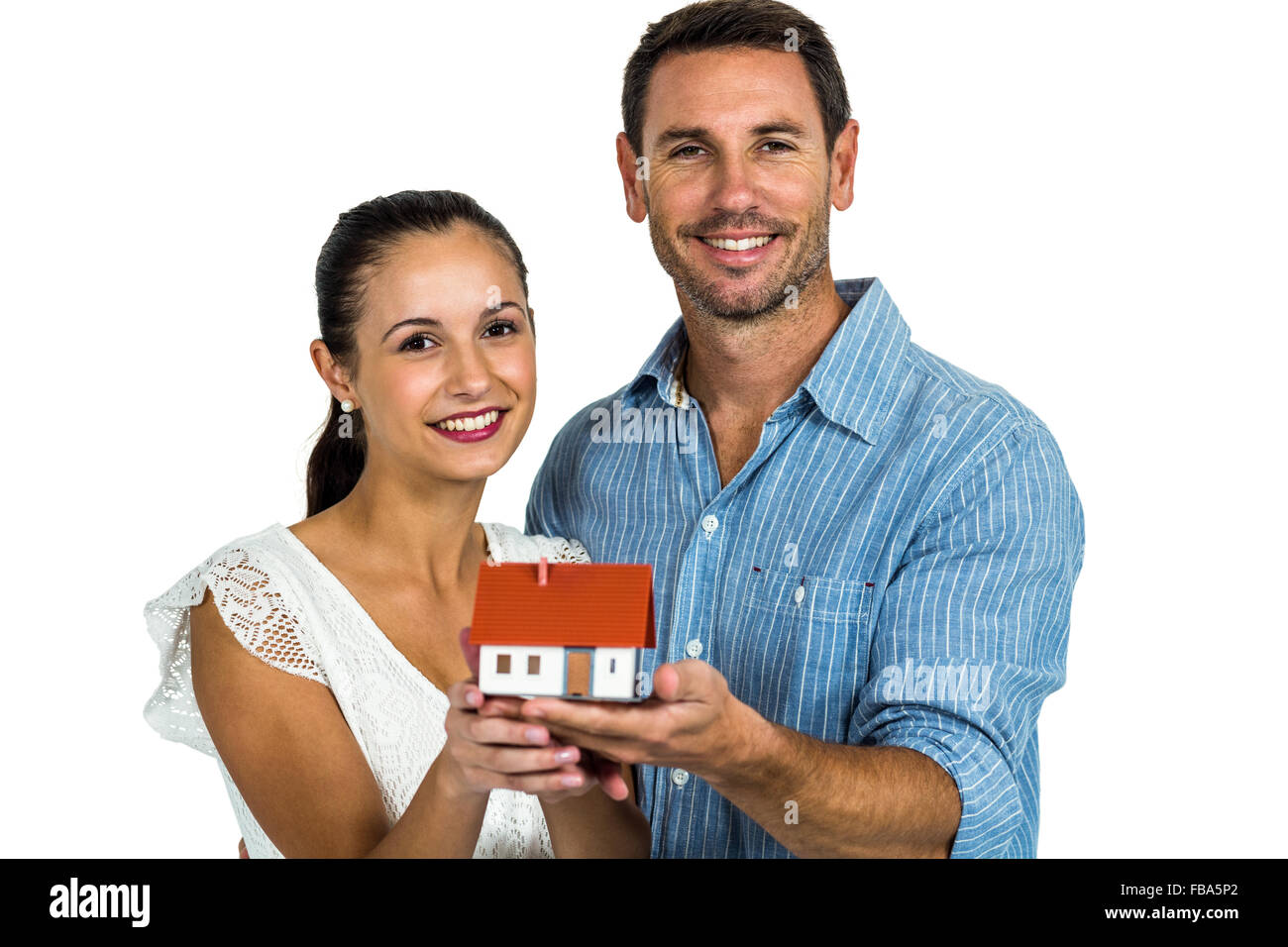 Smiling couple holding house model Stock Photo - Alamy