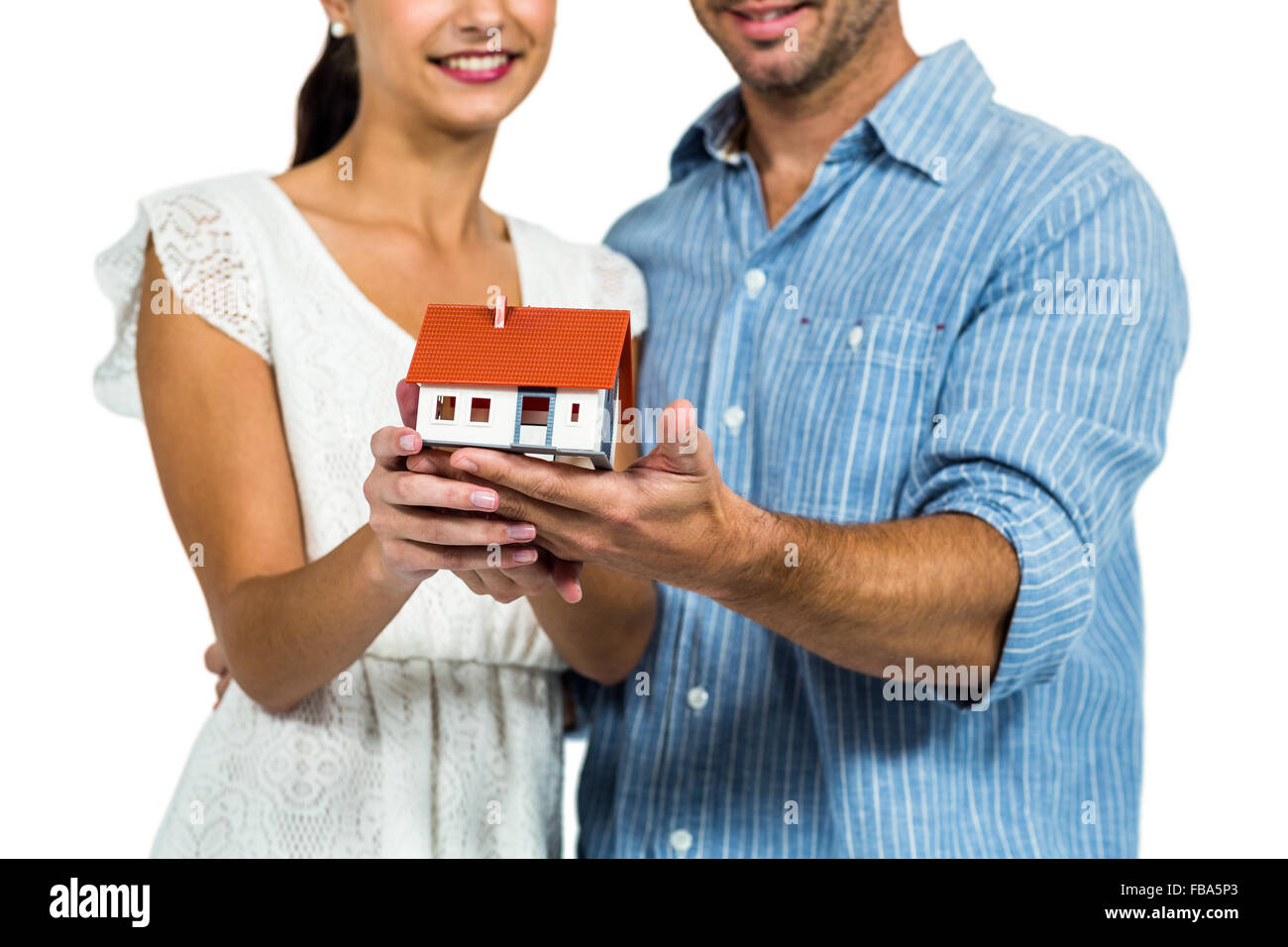 Couple holding house model Stock Photo - Alamy