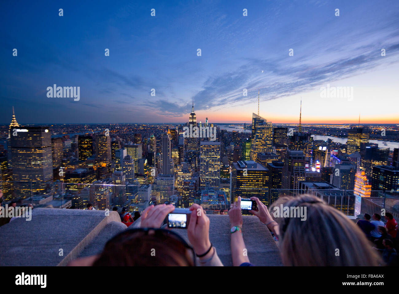 USA, New York State, New York City, Women photographing Manhattan at dusk Stock Photo