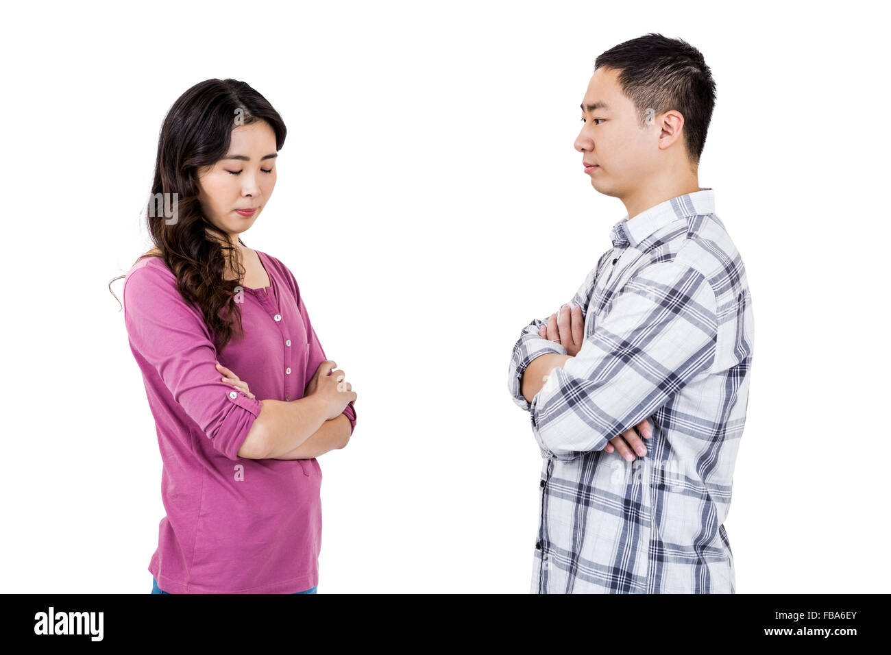 Upset couple standing with arms crossed Stock Photo
