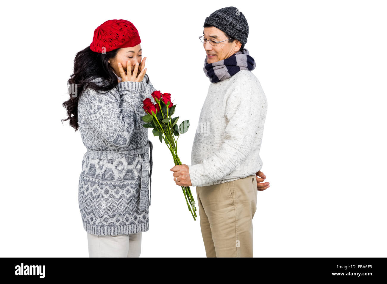 Older asian man giving his wife flowers Stock Photo