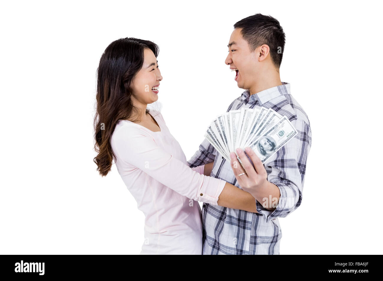 Cheerful happy couple holding money while standing Stock Photo - Alamy