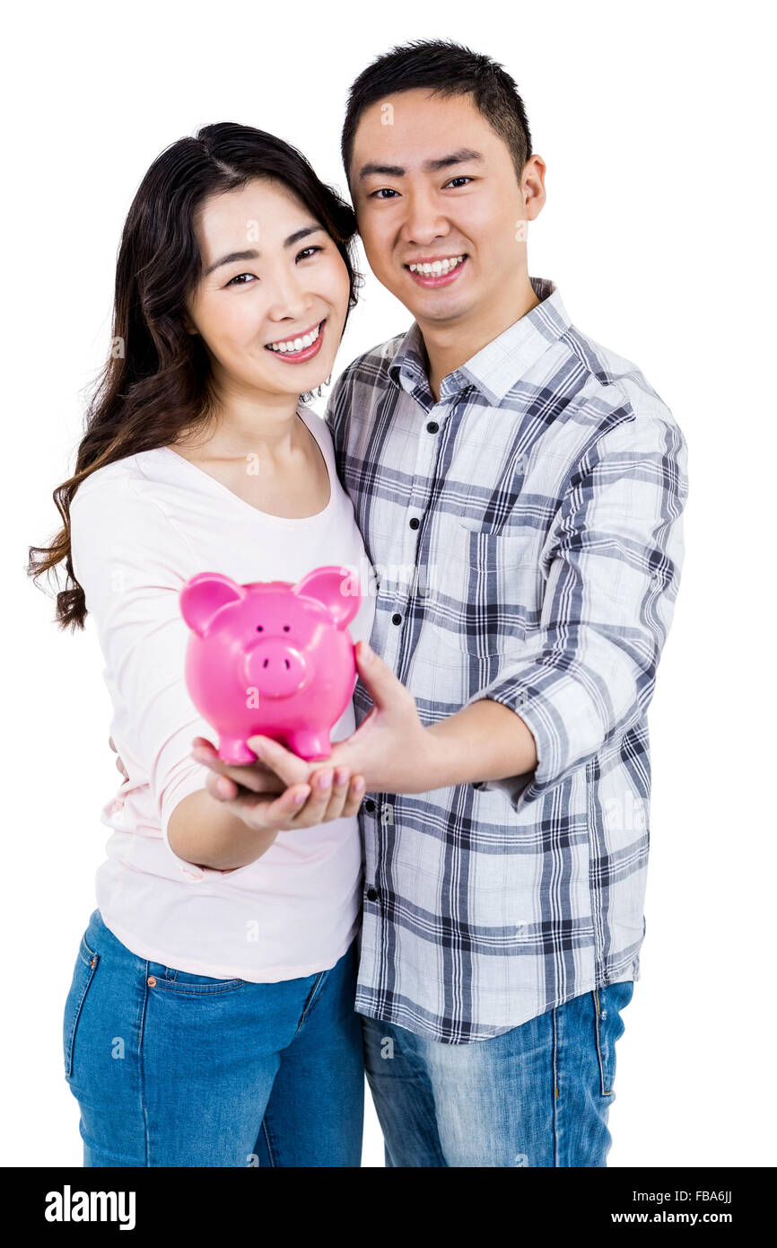 Portrait of happy smiling couple holding piggy bank Stock Photo - Alamy