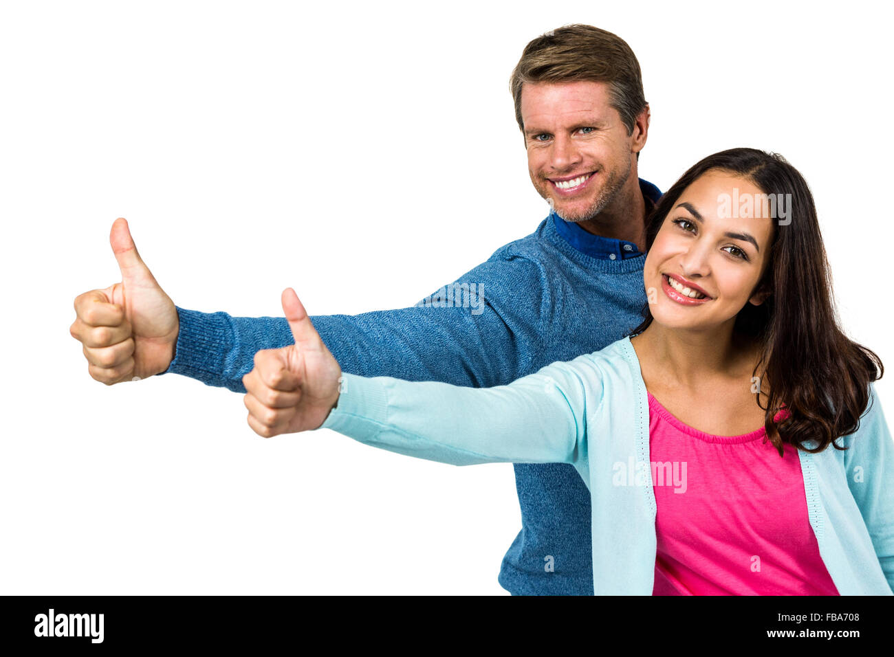 Portrait of smiling couple showing thumps up sign Stock Photo