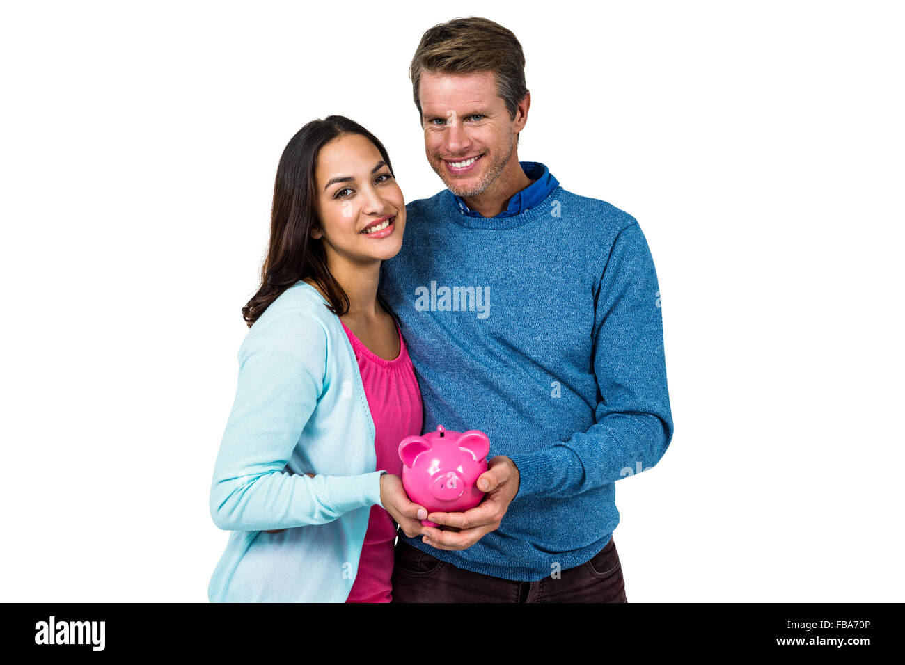 Smiling couple holding piggy bank Stock Photo - Alamy