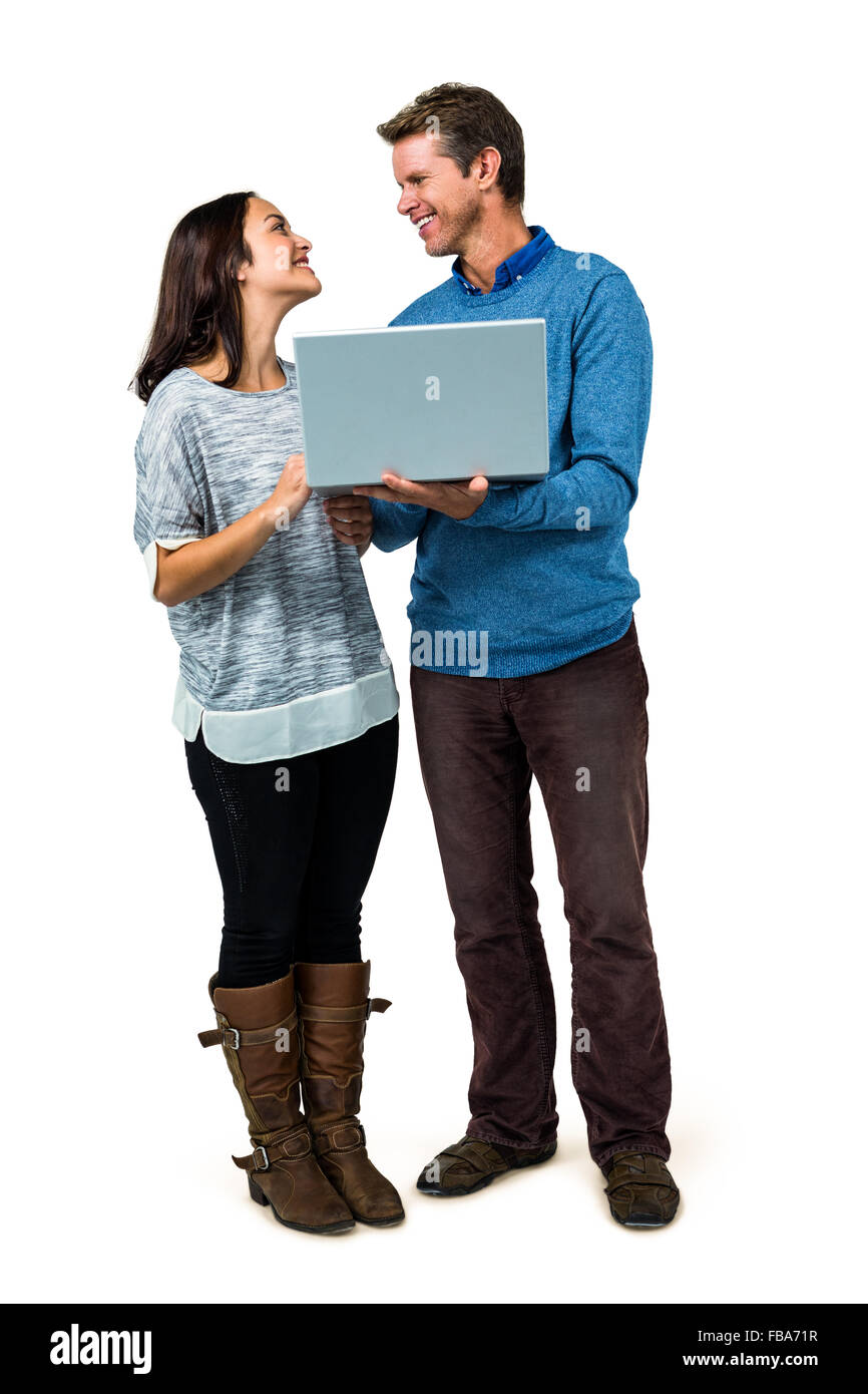 Smiling couple using laptop Stock Photo