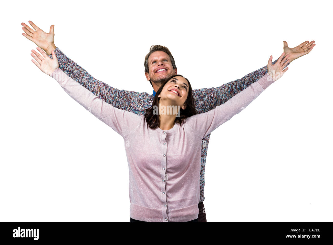 Smiling couple with arms raised Stock Photo