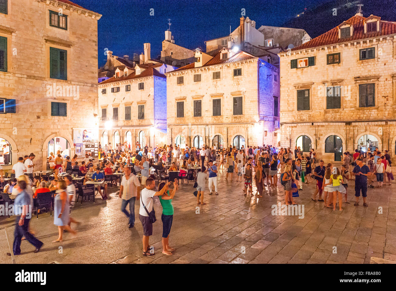 Tourists walk along Stradun, Placa or promenade which is the main street in the Old City of Dubrovnik,Dalmatia,Croatia, Europe. Stock Photo