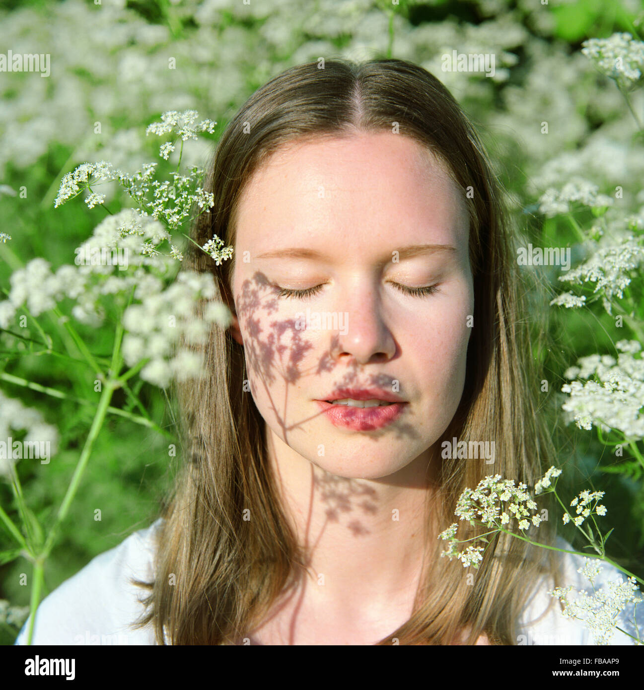 Finland, Portrait of young woman with closed eyes Stock Photo