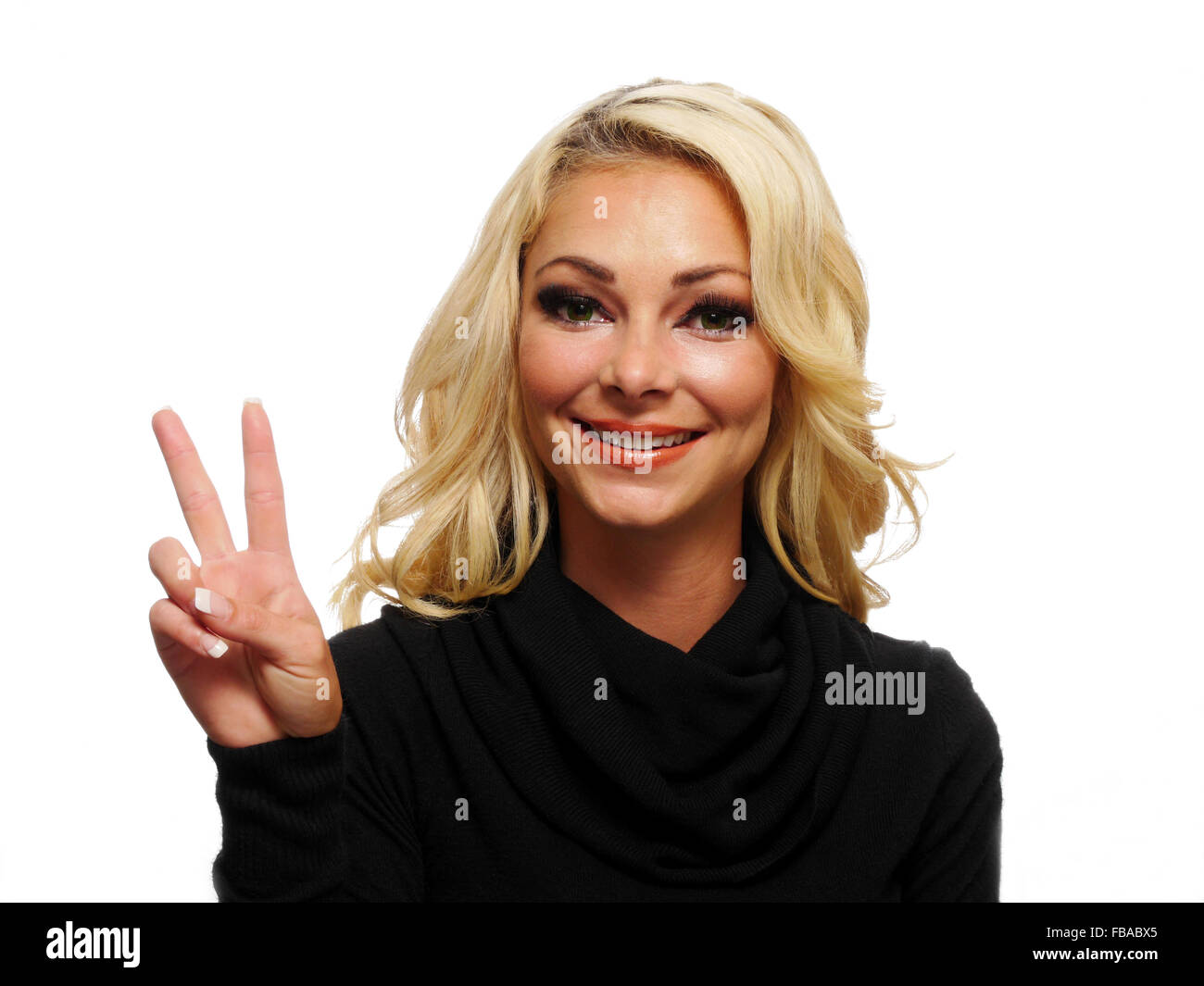 A attractive blond woman is holding up two fingers. Stock Photo