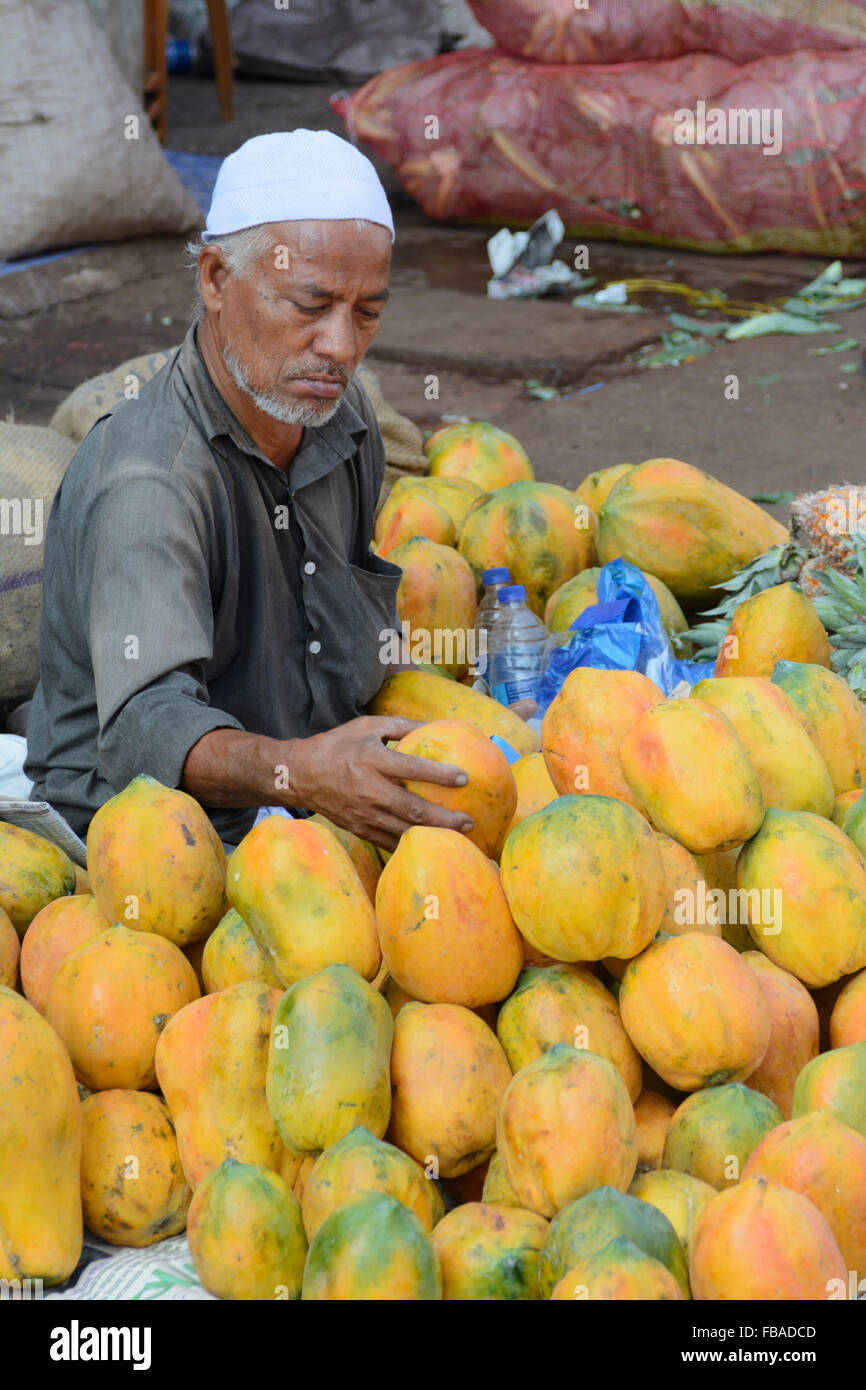 Indian man selling fresh fruit at Mapusa's lively Friday market, Mapusa