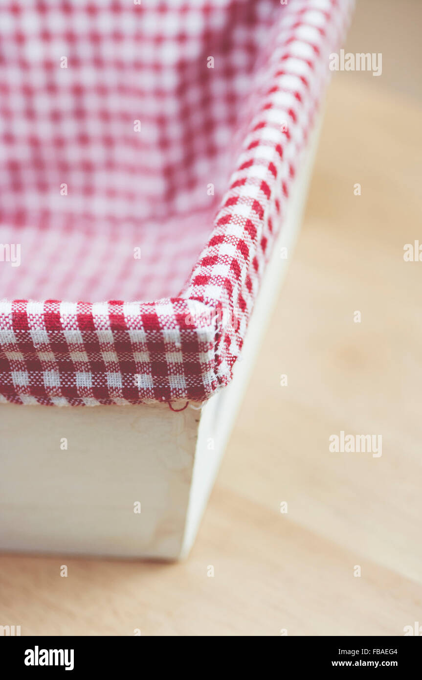 wood basket with engraved hearts and checkered fabric lining Stock